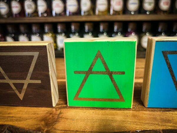 A wooden table with three different colored blocks.