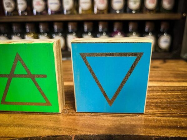 A close up of two wooden blocks on top of a table.