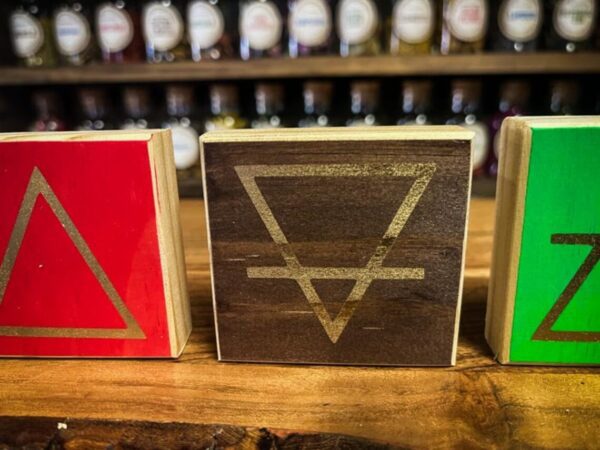 Three wooden blocks with a triangle and an arrow on them.