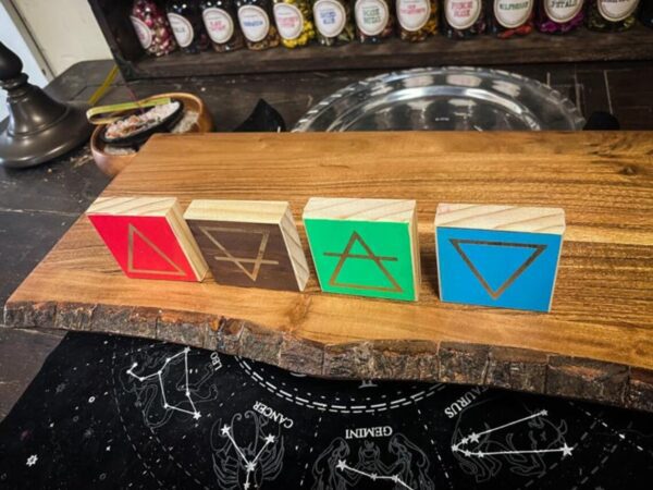 A wooden board with four blocks on top of it.