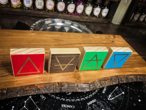 A wooden board with four different colored blocks on it.