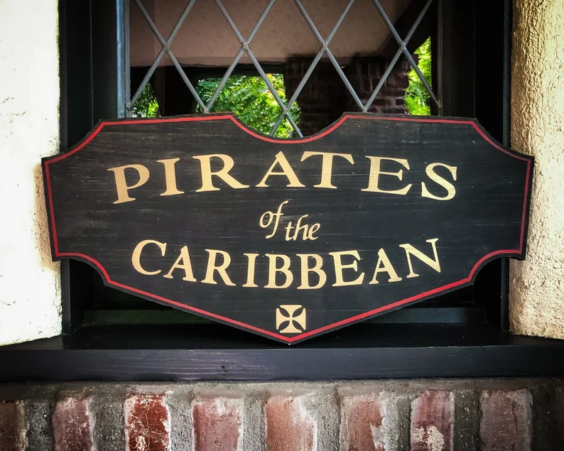 A sign that says pirates of the caribbean.