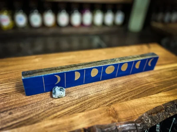 A wooden table with a blue tile on it