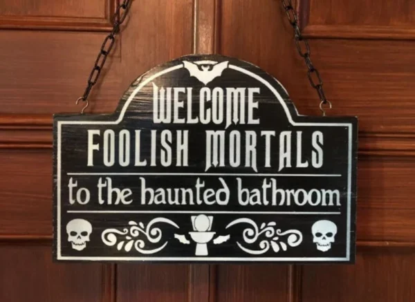 A sign hanging on the door of a house.