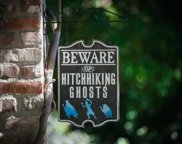 Beware of hitchhiking ghosts sign.