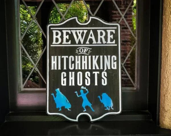 Beware of hitchhiking ghosts sign.