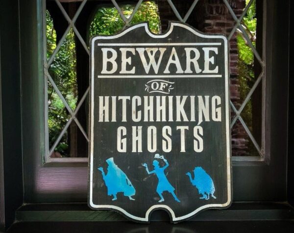 Beware of hitchhiking ghosts sign.