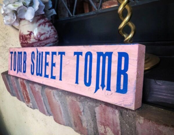 A pink and blue sign that says " 1 8 sweet tomb ".