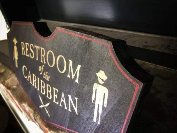 A restroom sign with the word " restroom of the caribbean ".