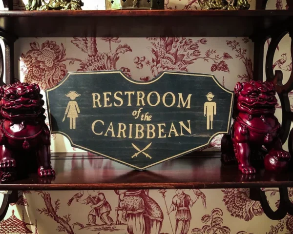 A sign that says restroom of the caribbean