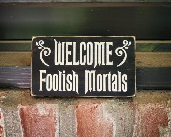 A sign that says welcome foolish mortals