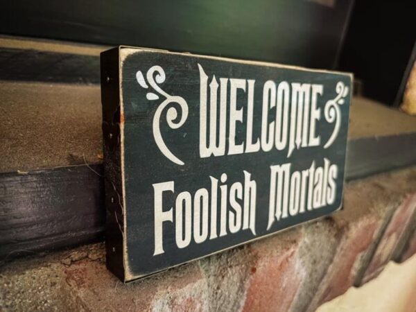 A sign that says welcome foolish mortals