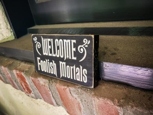 A sign that says " welcome foolish mortals ".