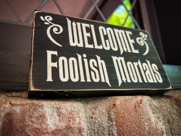 A sign that says " welcome foolish mortals ".