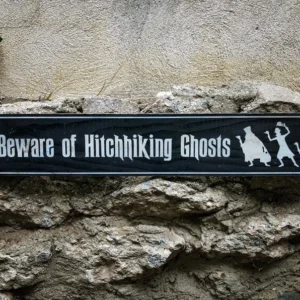 A sign that reads beware of hitchhiking ghosts.