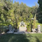 Formal garden with stone lion statues.