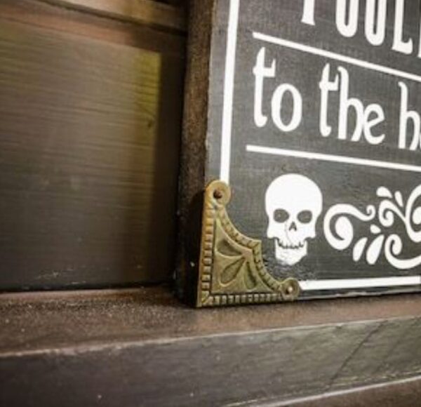 Ornate corner bracket on skull sign.