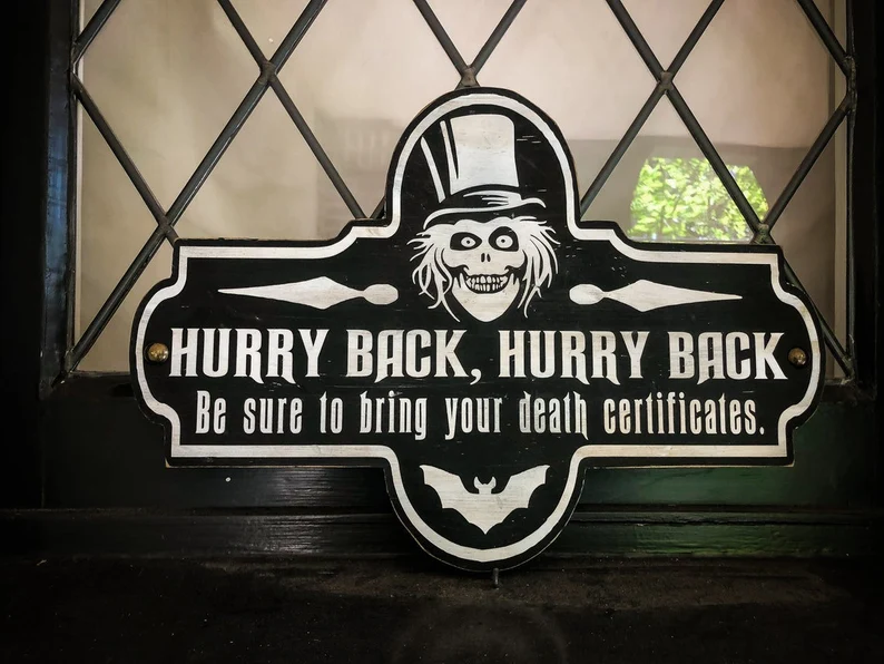 Here's an alt tag for the image: Ghost Host Hurry Back sign.