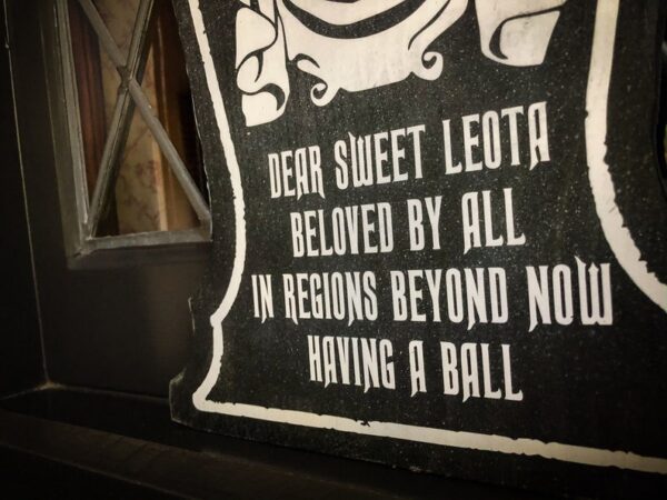 Here's an alt tag for the image: Leota's tombstone: having a ball.