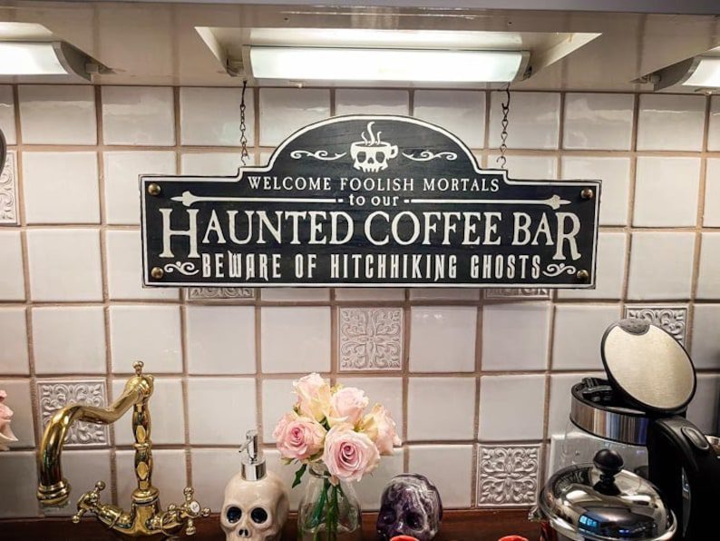 Haunted coffee bar sign with ghosts.