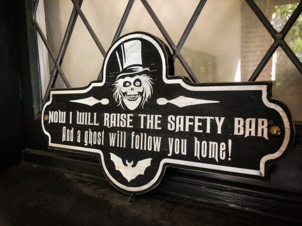 Haunted Mansion safety bar sign.