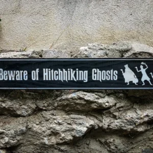 Beware of hitchhiking ghosts sign.