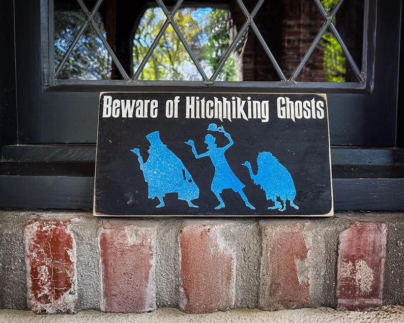 Beware hitchhiking ghosts sign.