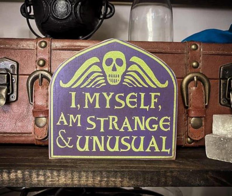 Here's an alt tag for the image: "I, myself, am strange & unusual" sign.