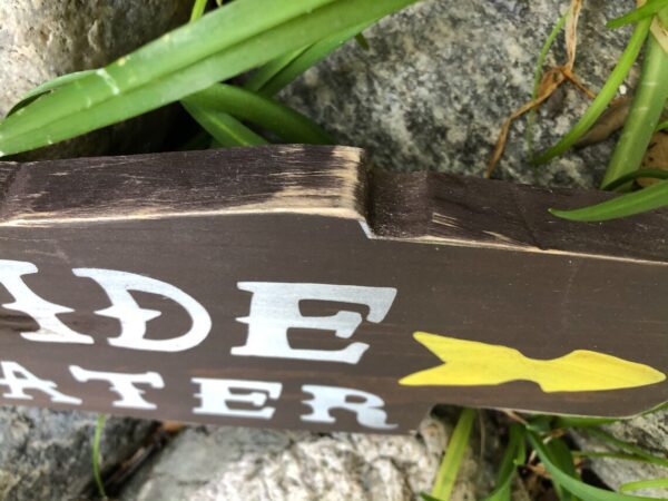 Here's an alt tag for the image: Brown wooden "side water" sign.