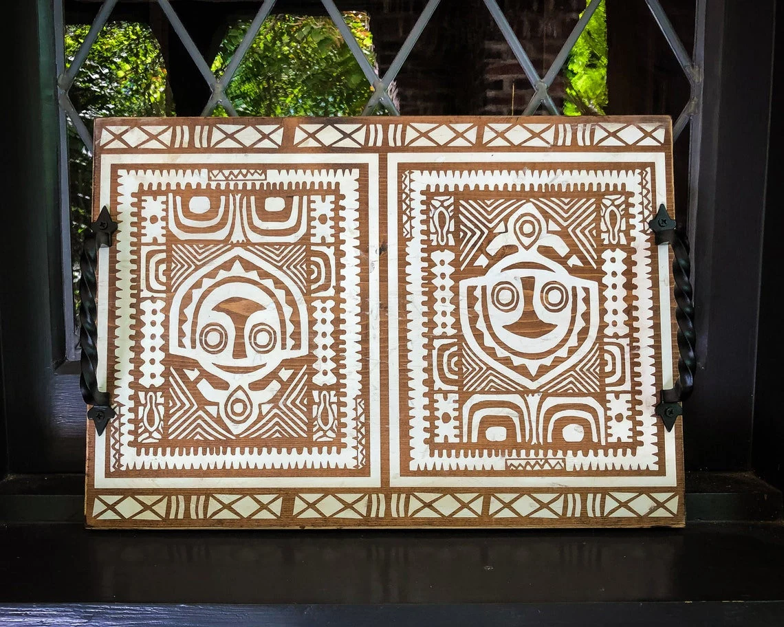 Wooden tray with Polynesian designs.