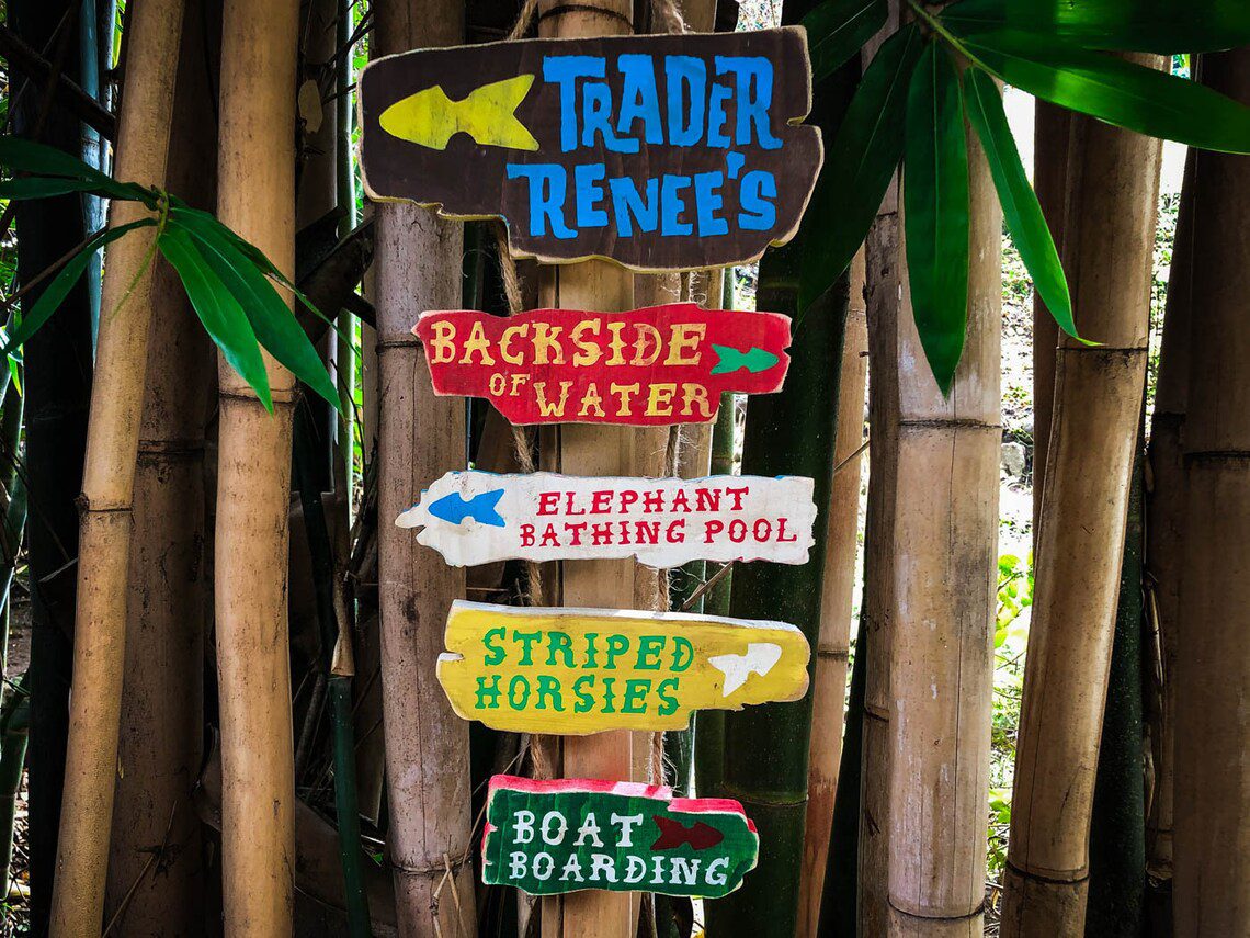 Colorful hand-painted directional signs.