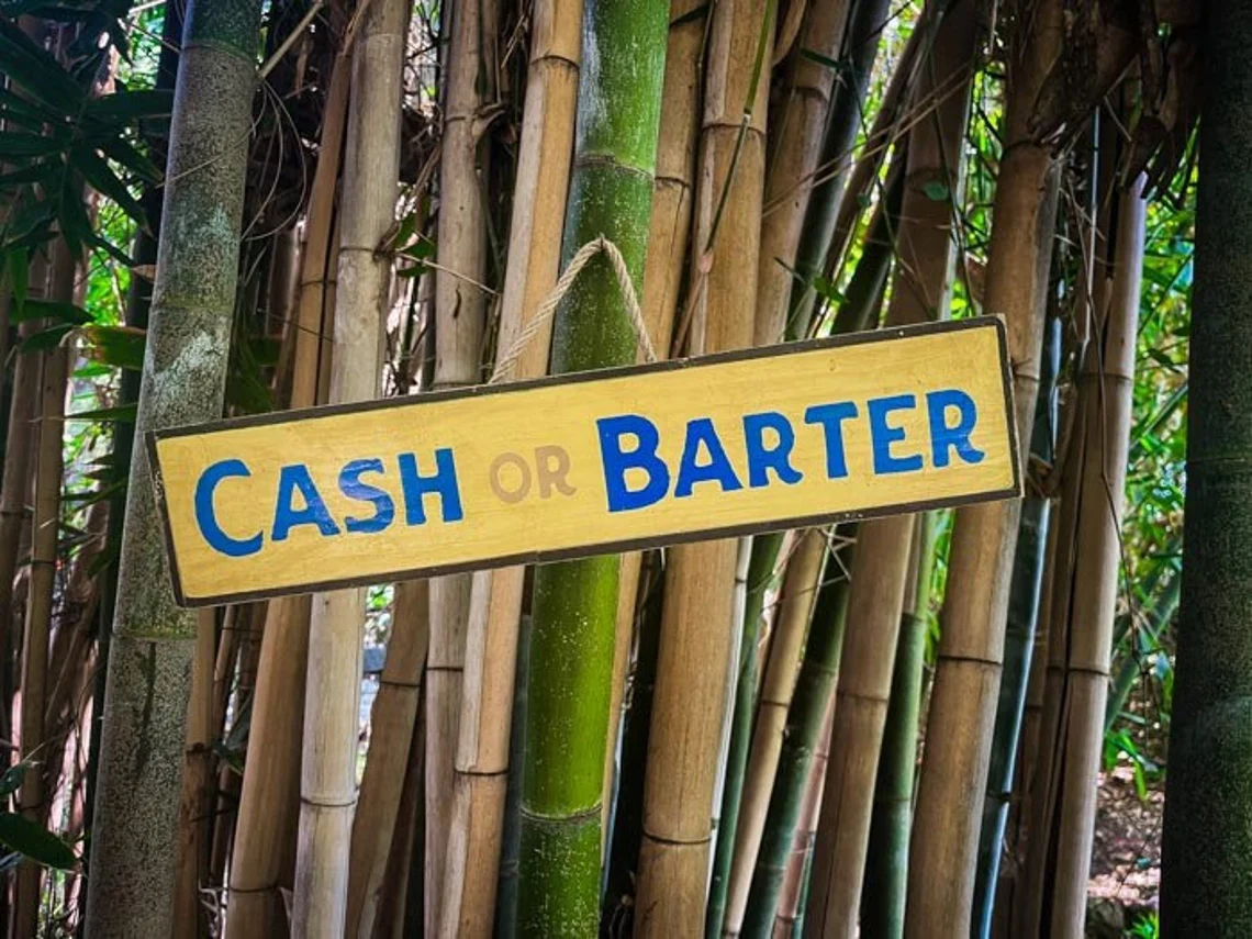 Cash or barter sign on bamboo.