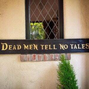 Sign saying "Dead men tell no tales."