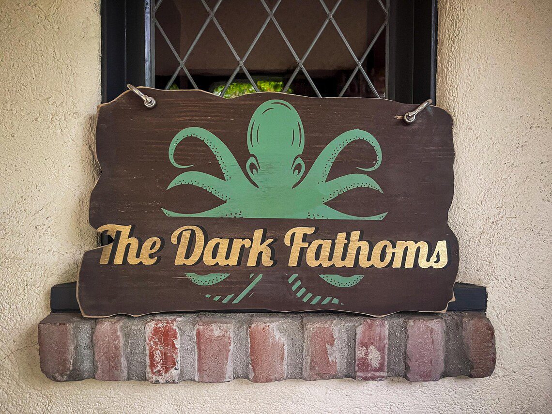 The Dark Fathoms sign with octopus.