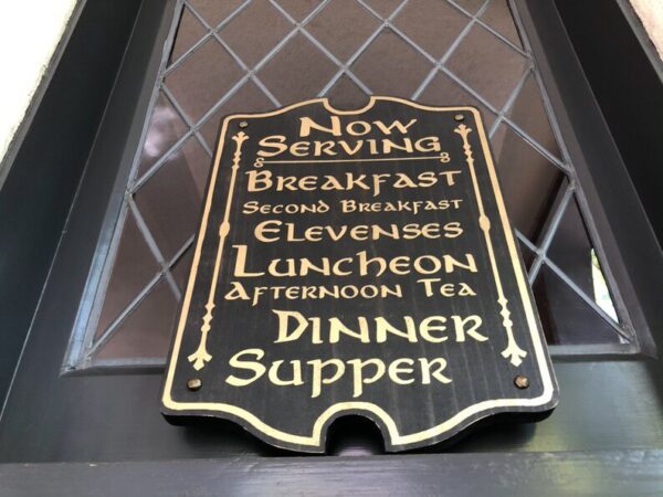 Here's an alt tag for the image: `Restaurant sign: Now serving breakfast, elevenses, luncheon, etc.`