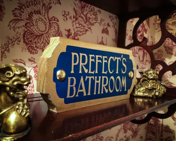 Prefect's bathroom sign on shelf.