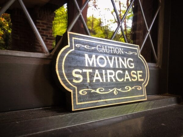 Caution: Moving Staircase sign.