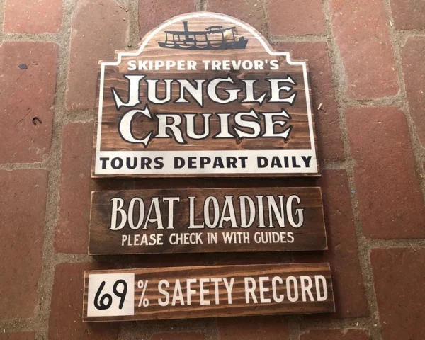 Jungle Cruise signs: boat loading, safety record.