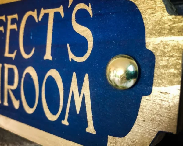 Prefect's Bathroom sign, gold lettering.