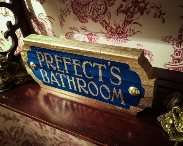 Prefect's Bathroom sign, gold and blue.