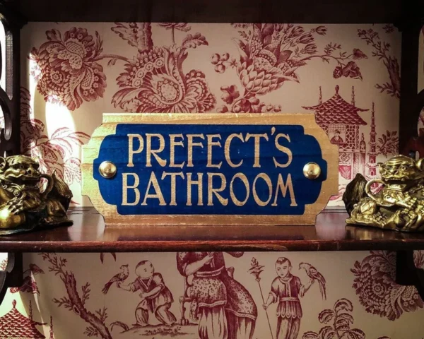 Prefect's Bathroom sign on shelf.