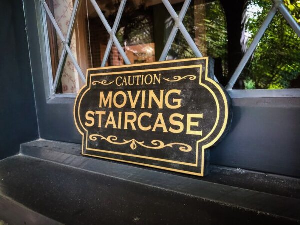 Caution: Moving Staircase sign.