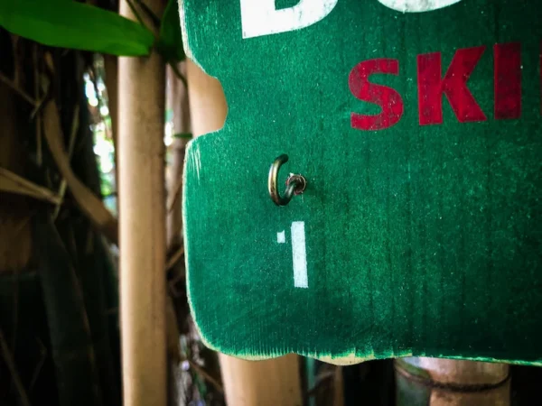 Green ski sign with hook and number one.