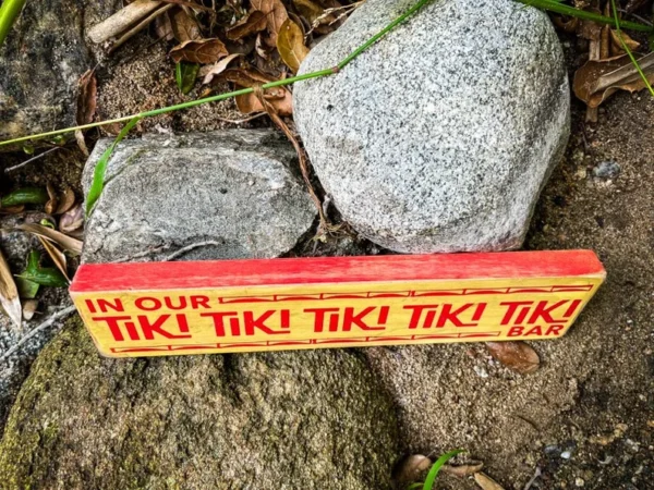 Tiki bar sign on rocks.