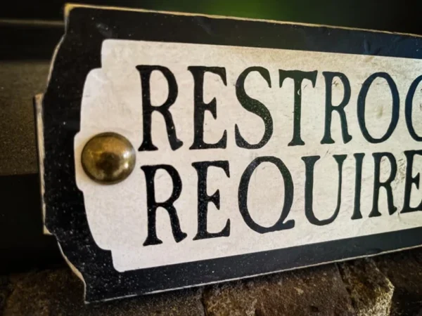 Here's an alt tag for the image: Restrooms Required sign.