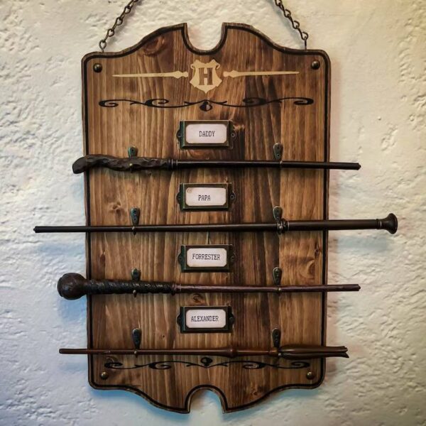 Wooden wand rack with family names.