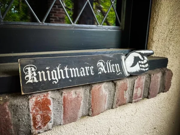 Nightmare Alley sign, pointing right.