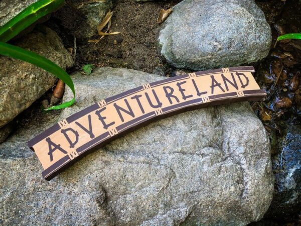 Adventureland sign on rocks.