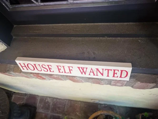 Here's an alt tag for the image: House elf wanted sign.