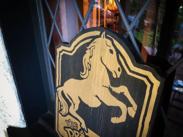 Wooden sign: prancing horse logo.